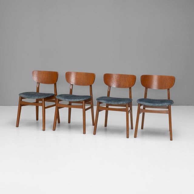 Set of 4 mid-century dining chairs, re-polished and newly covered in a smoky blue velvet. U.K circa 1960.