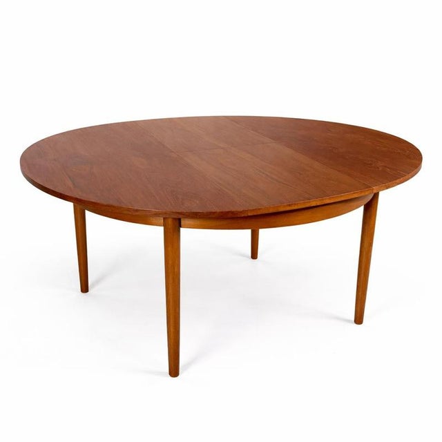 A classic Danish round extending dining table, designed with clean lines and understated elegance. The extension mechanism...