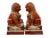 A stately pair of 20th century foo lions rendered in vibrant iron red porcelain. These guardian figures showcase...