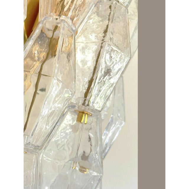 Contemporary and luxury wall sconce with transparent “poliedri” murano glass in venini style. "poliedri" glass elements...