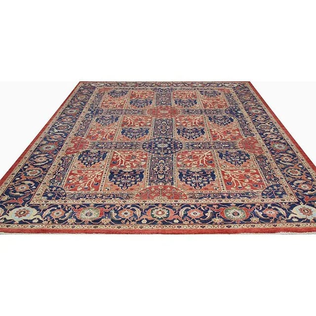 ACTUAL SIZE: 10’4″ x 13’9″ PRIMARY COLOR: Rust / Navy AGE: New ORIGIN: Pakistan MATERIALS: Wool FOUNDATION: Cotton...