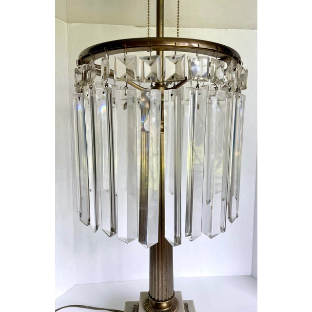 Here is a sophisticated and elegant table lamp from the early mid-century. The lamp features a two-tier marble and brass...