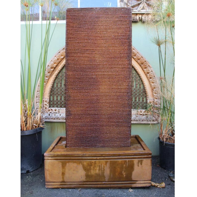 Beautiful rust stained cement ripple wall fountain. Includes pump and ready to plug in to your existing electrical outlet....