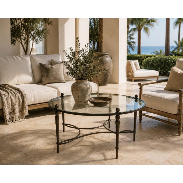 A substantial Michael Taylor Designs “Montecito” round cocktail or coffee table, circa 2000s, combining the relaxed...