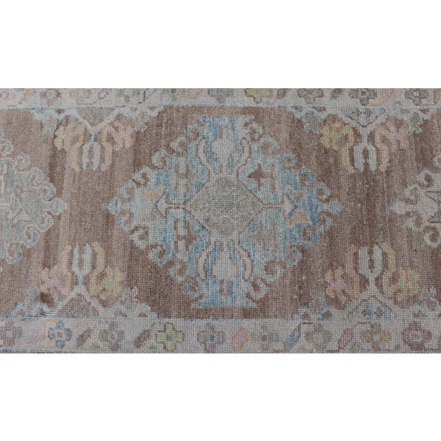 Tribal Long Turkish Oushak Runner With Pale Blue, Soft Yellow, and Light Brown Motifs For Sale - Image 3 of 13