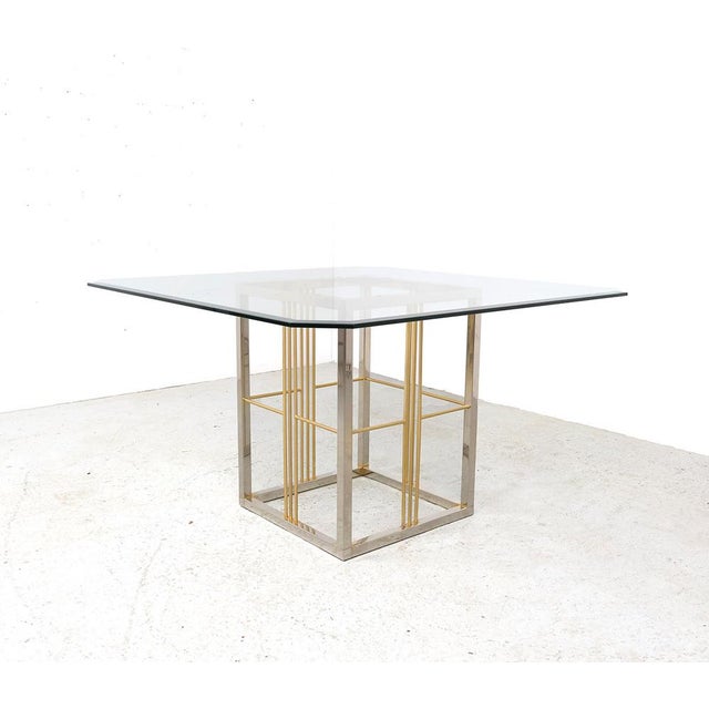 Vintage dining table from the 1970s, presumably of italian origin. this stylish table is characterized by a square brass...