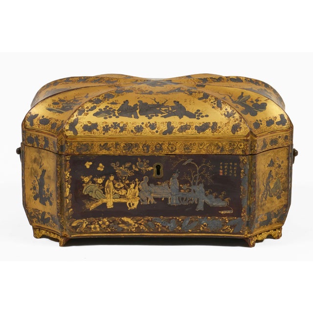 Chinoiserie Chinese Export black lacquer octagonally shaped wooden tea caddy features gilded and silver gilt designs and...