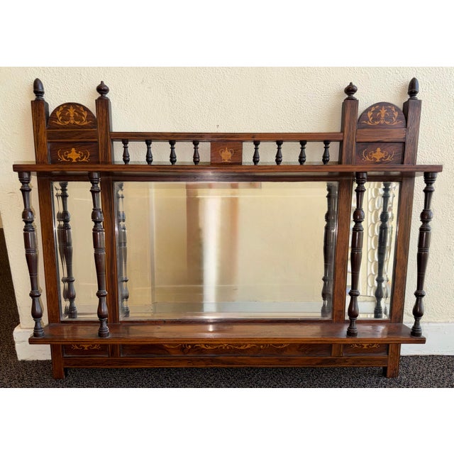 This listing is for an antique English Edwardian mirror. The mirror is made from wood. It features a Moorish inspired...