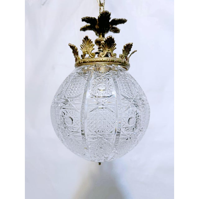 This is an osler cut glass spherical glass lantern with decorative brass mount with the segmented cross cut crystal...