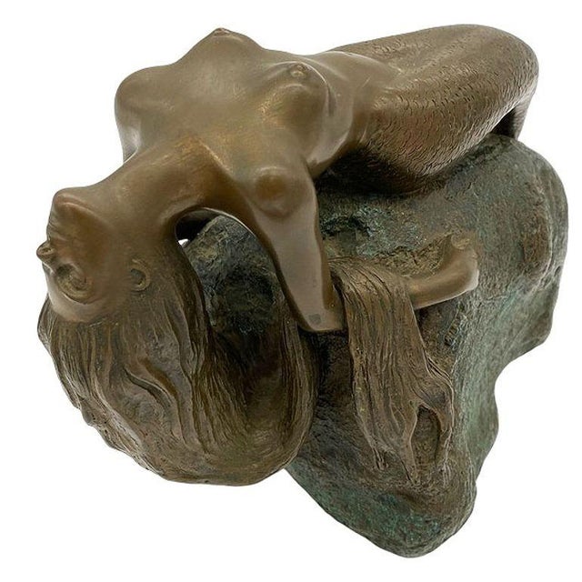 Cast Bronze nude mermaid statue on beach Rock featuring a young nymph like mermaid by James Siebert dated 1984. This...