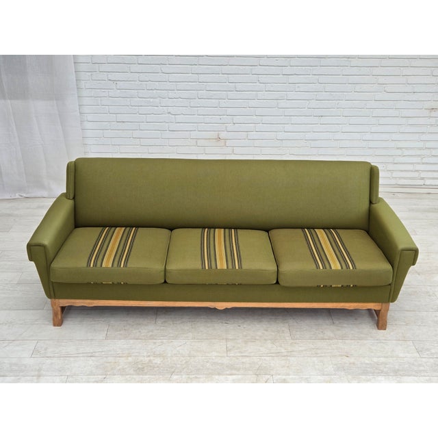 1970s, 3-seater Danish sofa. Original green furniture wool, oak wood, springs in the seat cushions. Wear consistent with...