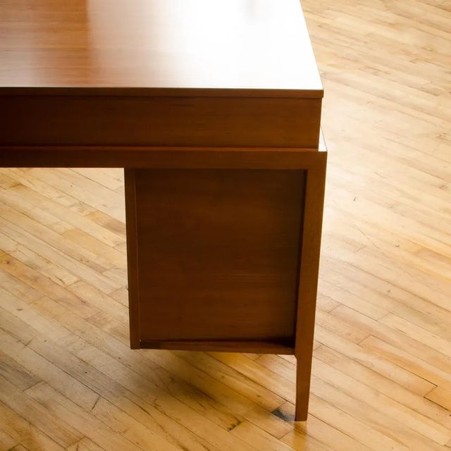 A Mid-Century American walnut desk with side extension designed by John Van Koert for Drexel circa 1960. Materials: Wood,...