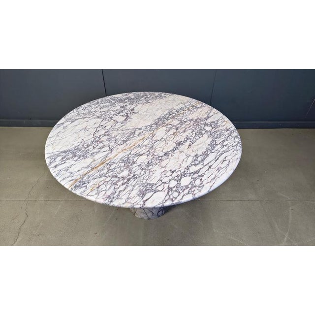 Spectacular round 'viola' marble dining or center table with a conical shaped base. Beautiful veins in the marble. Very...