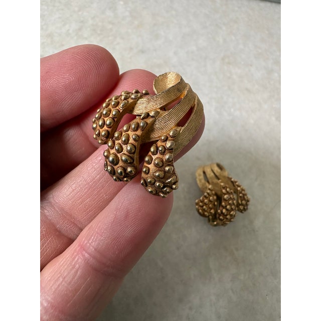 vintage gold-tone textured cluster clip-on earrings featuring a dimensional, multi-lobed design with stippled bead accents...