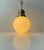 A yellow cased opaline glass and brass set ceiling light manufactured in Denmark during the 1930s. It can be chain...