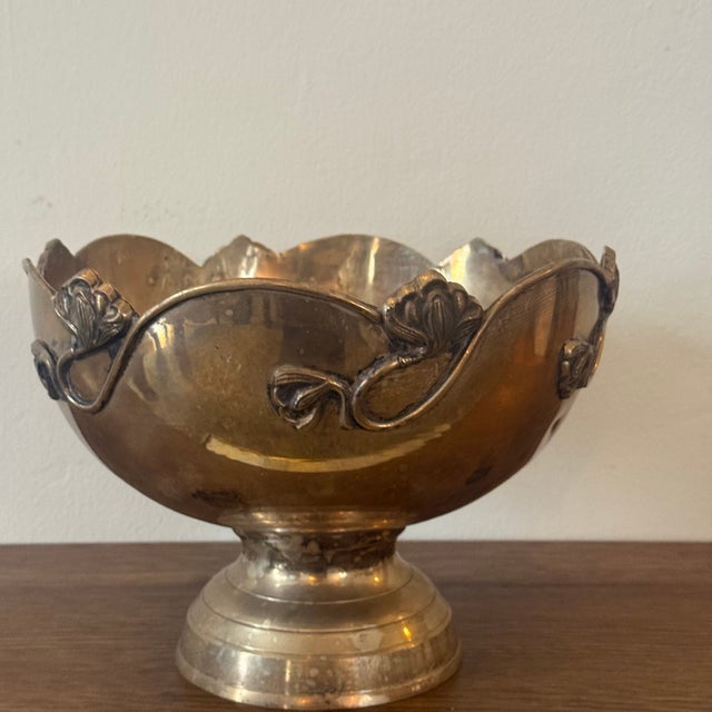 A French Art Nouveau silverplate champagne cooler featuring a scalloped edge, decorative floral detailing, and a classic...