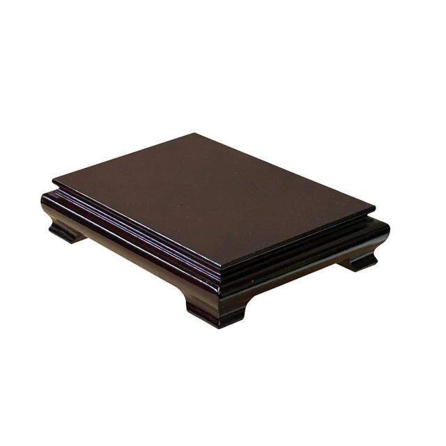 Present your items with understated elegance using the Reddish Brown Wood Simple Flair Legs Rectangular Display Stand...