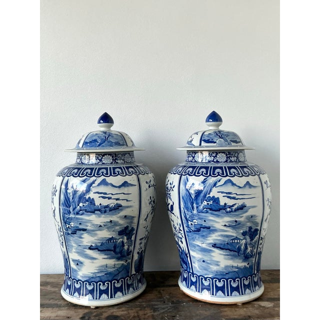 Make a commanding statement in your interior with this spectacular pair of monumental vintage porcelain temple jars....