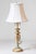 This charming mid-20th-century lamp is crafted from painted wood and adorned with polychrome floral decorations and gilded...
