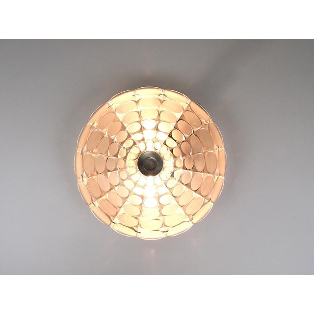 A beautiful and decorative round op-art wall light / sconce from the 1970s, manufactured by peill & putzler, germany. It...