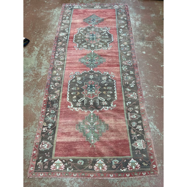 Vintage Turkish runner, hand-knotted in Turkey from 100% wool. Measuring 4’11” x 12’2”, the rug features a traditional...