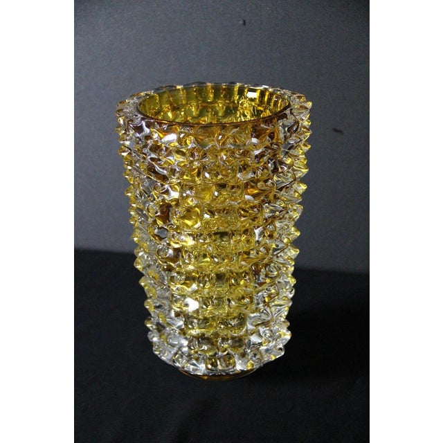 This Murano glass vase is truly impressive, with a vibrant and unusual color that ranges from orange to amber. It is...