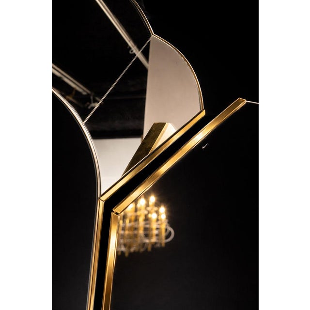 An elegant triptych mirror attributed to the prestigious Maison Jansen, created in the 1970s, in a distinctly Hollywood...