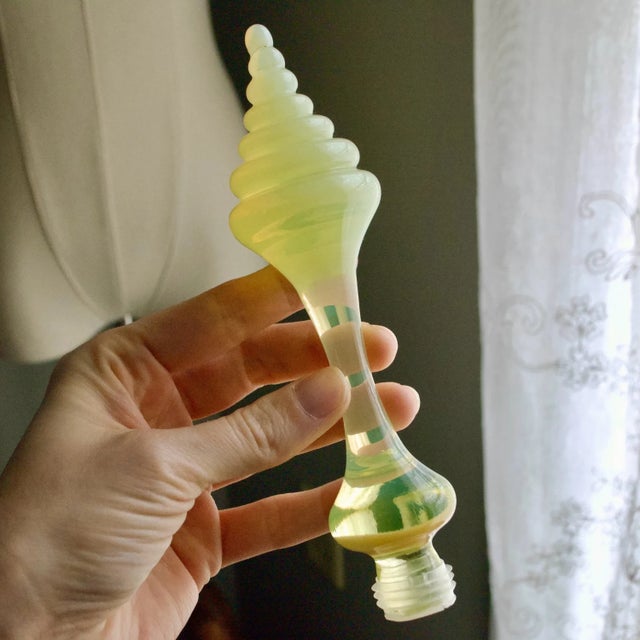 Elegant decanter composed of a clear crystal bottle paired with a uranium glass stopper in Bristol opaline-style yellow...