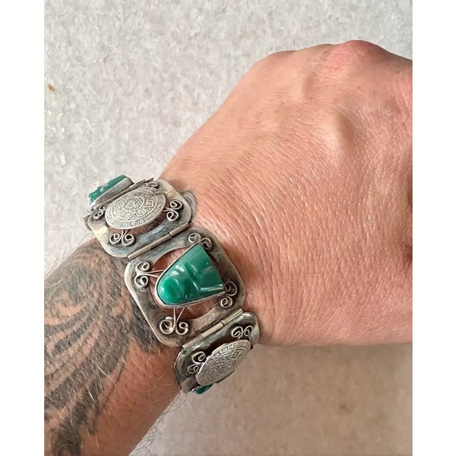 Wonderful 1940s sterling silver and green onyx Aztec design bracelet. Made in Mexico. Stamped "Sterling." This bracelet...