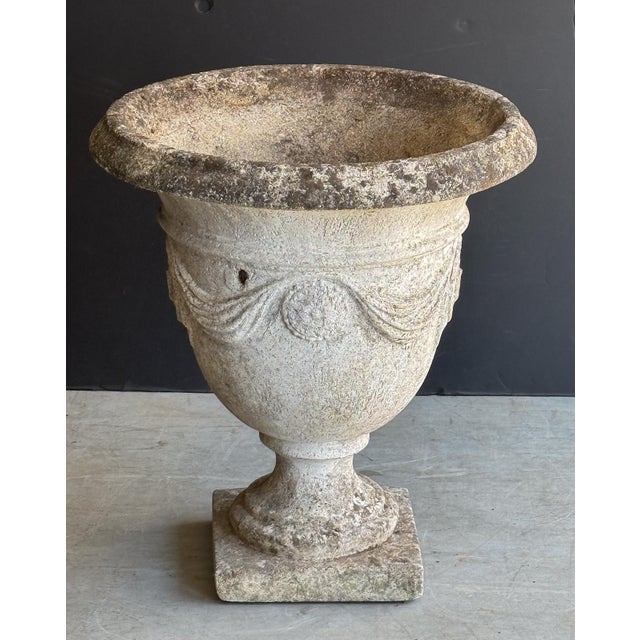 A fine English garden planter pot or urn of composition stone in the Country House style, featuring a beautiful garland...
