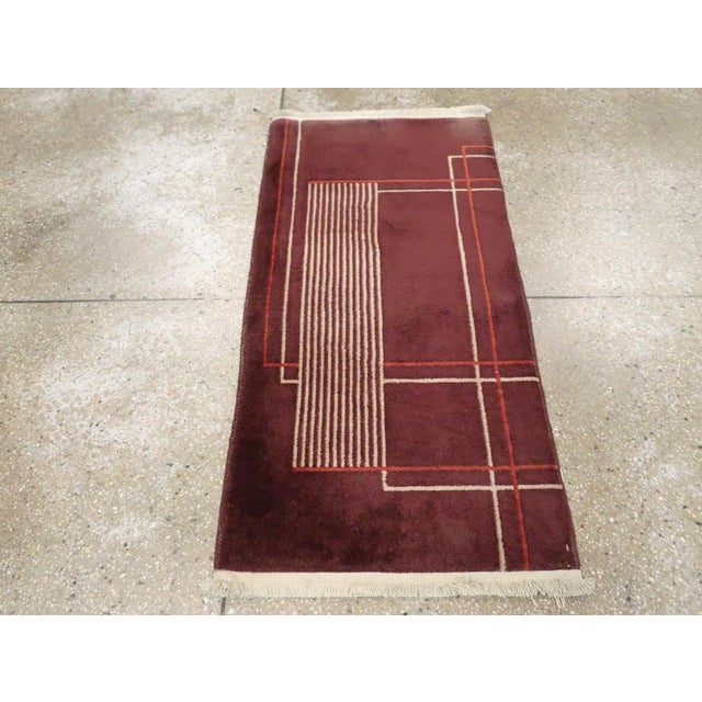 A vintage Chinese Art Deco throw rug handmade during the mid-20th century. Measures: 2' 0" x 3' 10".
