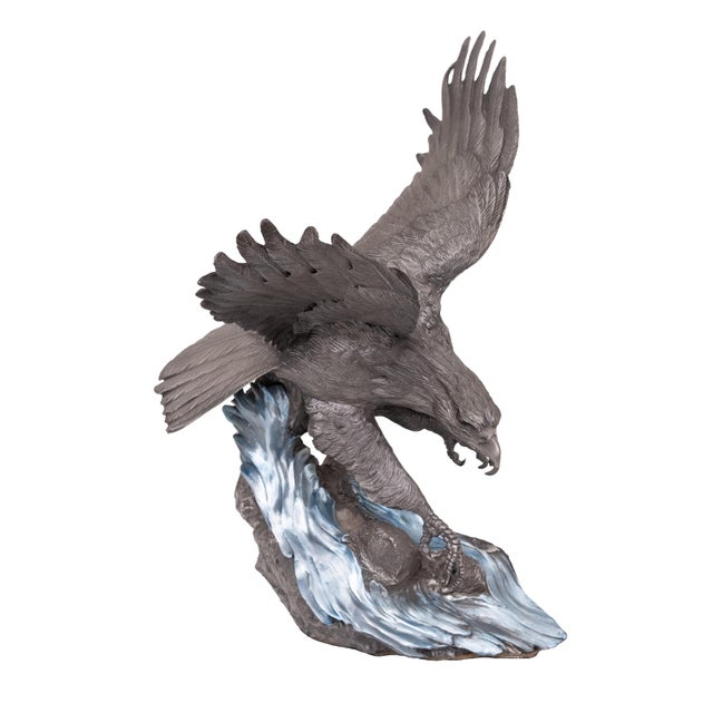 Beautiful pewter work by Paul Brunelle, representing a North American fish eagle spreading its wings and swooping down on...