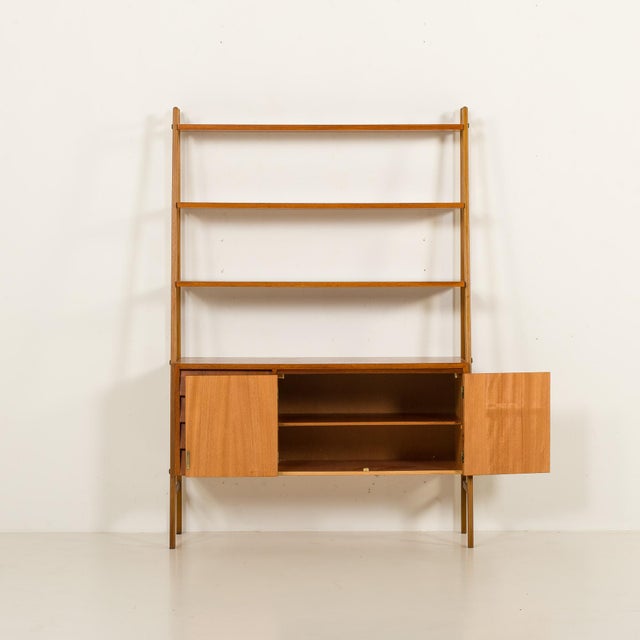 This elegant scandinavian mid-century shelving unit with an integrated desk was made in the 1960s. overall size is h: 168...