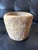 Striking hand-carved wood vessel with an exceptionally weathered, organic character. The surface is richly marked by...