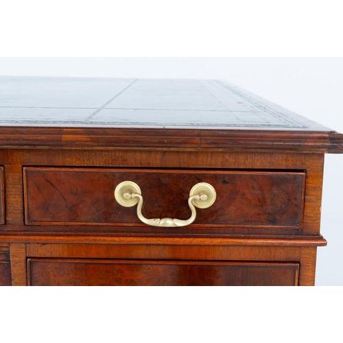 This desk is raised upon a plinth base Circa 1880 The front of the desk having an arrangement of 9 mahogany lined...