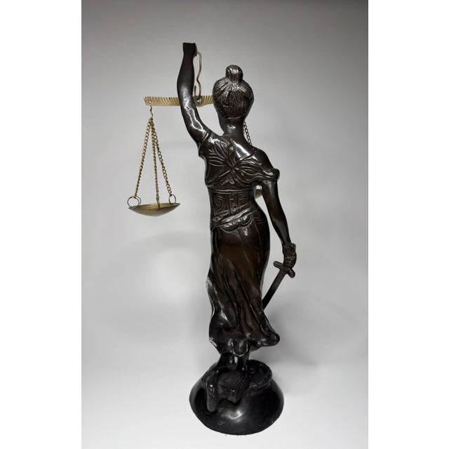 Exquisite detail radiates throughout this Mediterranean figurine in a neoclassical style. The bronze patina over cast iron...