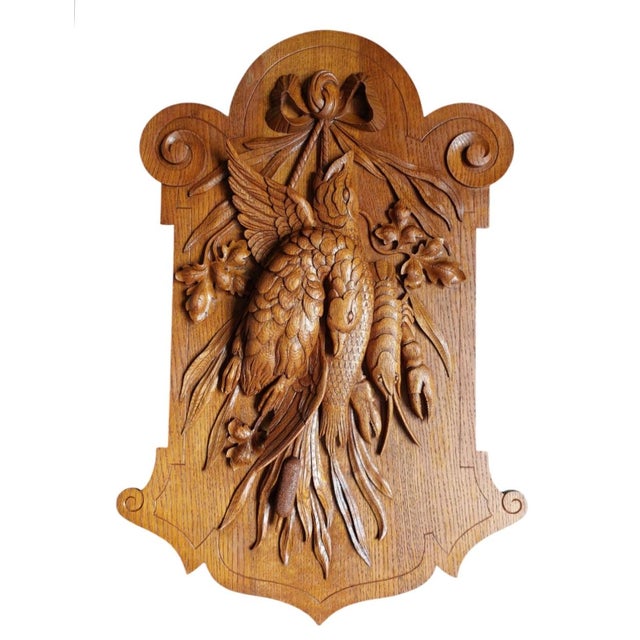 A beautiful black forest hunting trophy carved from oak. with beautiful fine detailed ornaments. A young deer, quail bird,...