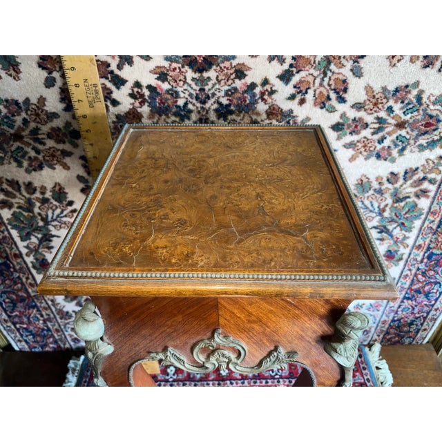 A beautifully aged vintage and possibly antique French table with bronze accents. Minor veneer loss and crackling as shown...