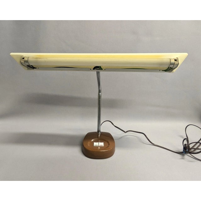 A mid-century Mobilite gooseneck desk lamp with fluorescent light and adjustable stem. The vintage office light has a...
