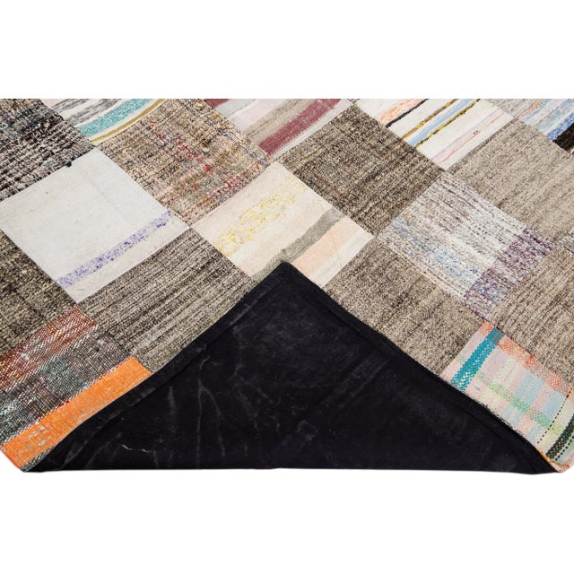 Beautiful vintage Turkish hand-knotted wool rug with a brown field. This piece has multicolor accents in a gorgeous all-...