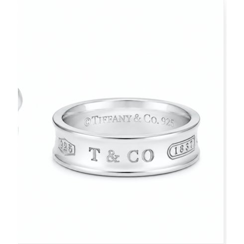 A vintage Tiffany & Co. 1837 concave ring in 925 sterling silver, size 7, featuring a sleek and timeless design in...