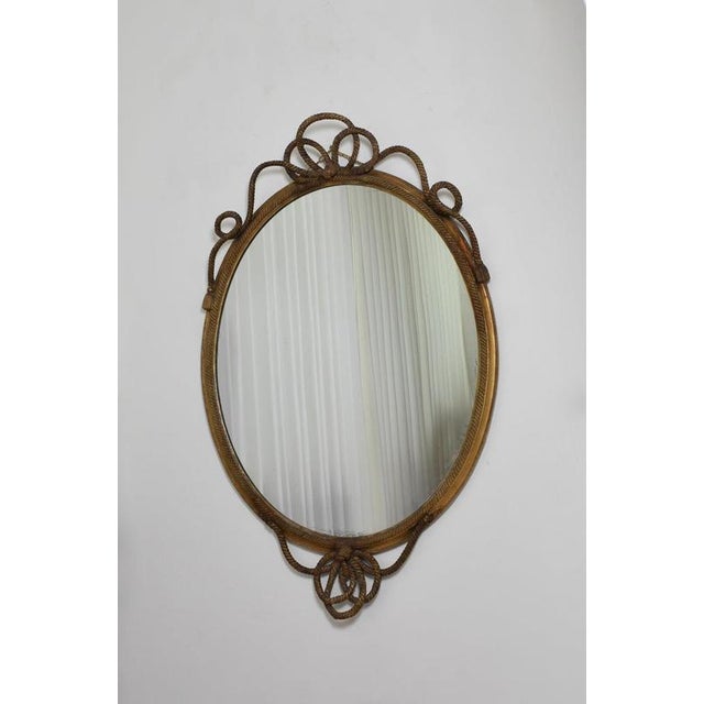 Important oval trimmings and pompoms mirror, XIXth c. Height: 172 cm - 67.72 in Length: 107 cm - 42.13 in Width: 3 cm -...