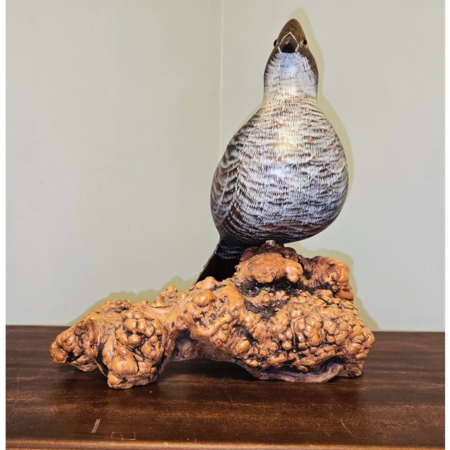 A beautifully detailed hand‑carved, ruffed grouse by wildlife artist Vicki Hughes, known for her lifelike avian studies...