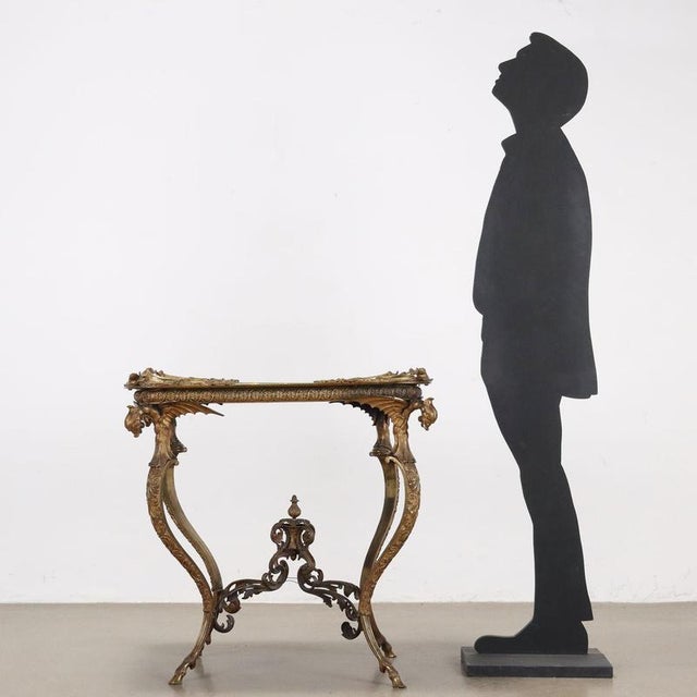 Tray table, England, second half of the 19th century. Made of finely chased and gilded bronze with a papier maché top....