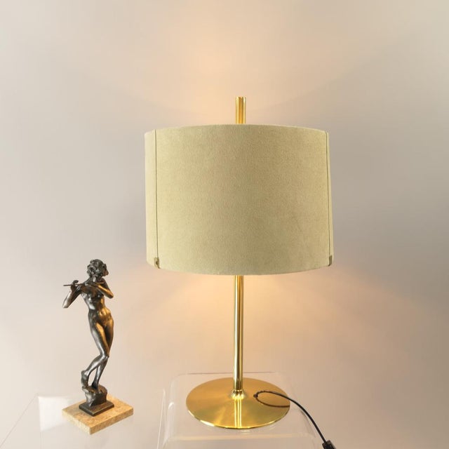 Rare table lamp with suede lampshade, the inside is gilded. Brass base and stem lacquered. Dimensions: Height: 75 cm Stand...