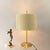 Rare table lamp with suede lampshade, the inside is gilded. Brass base and stem lacquered. Dimensions: Height: 75 cm Stand...