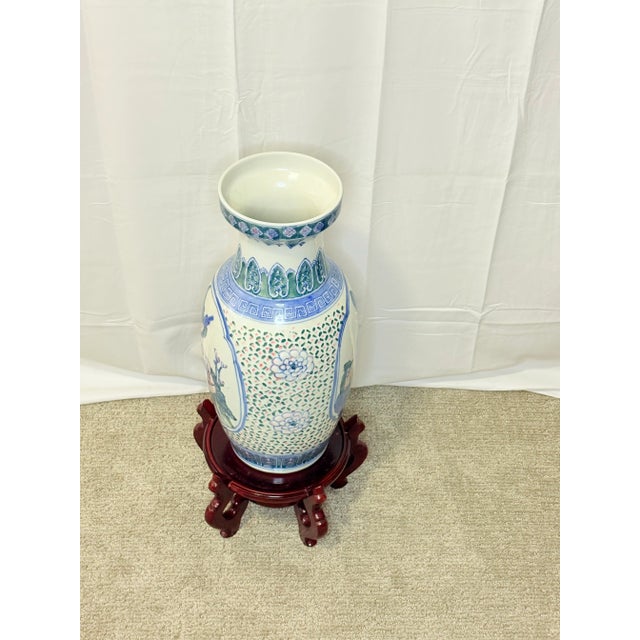 This is a Vintage Chinese Porcelain Vase adorned with intricate pink floral and bird motifs including a prominent blue...