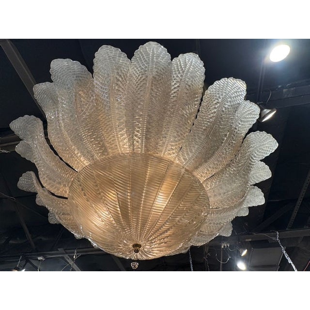 The Large Scale Murano Glass Flush Mount Chandelier in "Fume" color is a striking lighting fixture. . This chandelier, in...