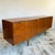 Dunvegan teak sideboard designed by Tom Robertson for A.H. McIntosh, circa 1960s. Features sculpted handles, tapered legs,...
