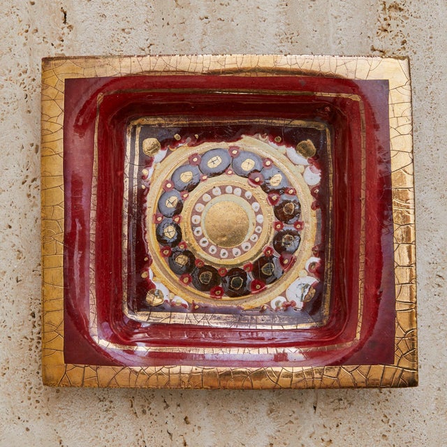 A 1970s French ceramic tray by Georges Pelletier. The square form is richly worked in deep crimson glaze, its surface...